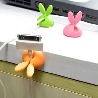 Colorful bunny-shaped cable holders designed to keep your charging cables organized and tangle-free on your desk. Brighten up your workspace with these fun and functional accessories.