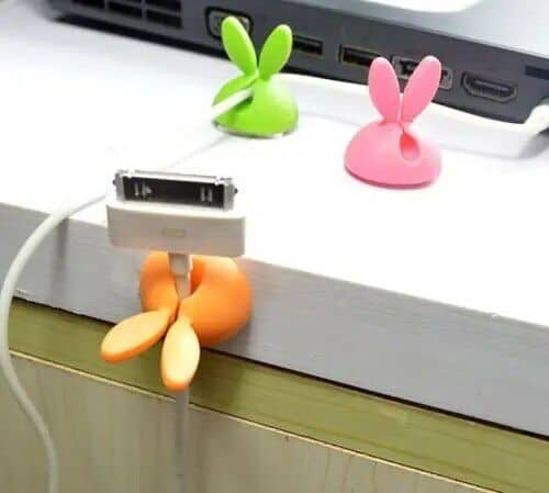 Colorful bunny-shaped cable holders designed to keep your charging cables organized and tangle-free on your desk. Brighten up your workspace with these fun and functional accessories.