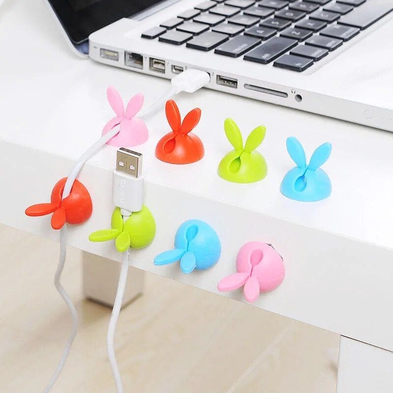 Brightly colored bunny-shaped cable protectors for USB and charging cords, preventing damage and adding fun to your tech accessories. Perfect for desk organization and cable safety.