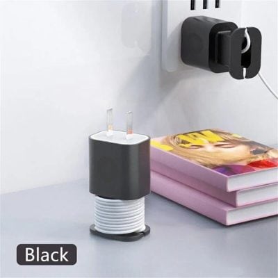 Power adapter plugged into wall socket with charging cable, sleek black design.