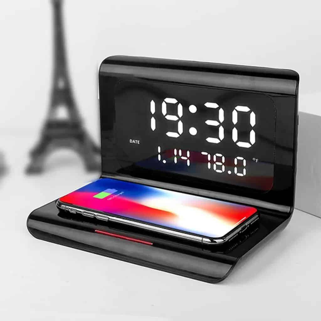 Modern digital alarm clock with charging dock, featuring large illuminated display for easy time and date viewing, perfect for bedroom or workspace, supports daily productivity and convenience.