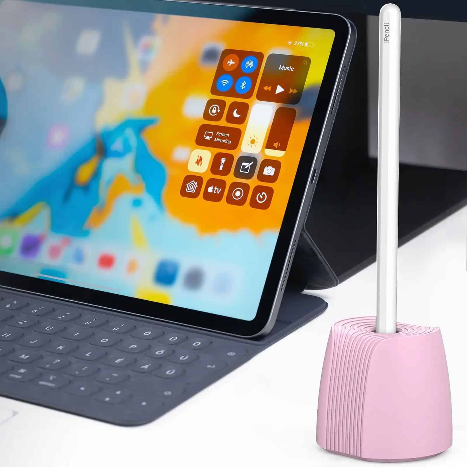 IPad with colorful screen displaying control icons, keyboard, and a pink dust blower for aesthetic skincare care.