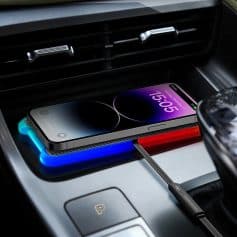 Wireless charging pad for smartphones in vehicle interior, fast charging, compatible with iPhone and Android, modern car accessory, convenience, car interior tech.