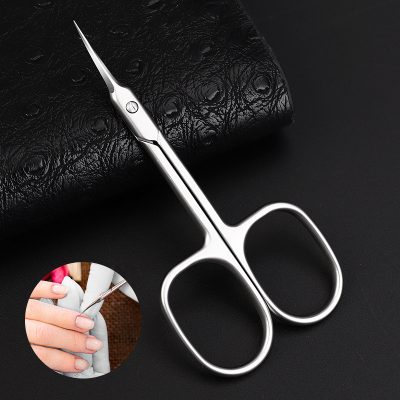 High-quality, stainless steel manicure scissors for precise cuticle and nail care, ideal for professional salons and home use. Ergonomic design ensures comfort and accuracy.