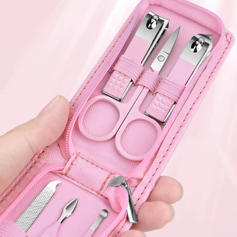 Nail care set with manicure tools including scissors, tweezers, and nail file in a pink case, ideal for grooming and personal care.