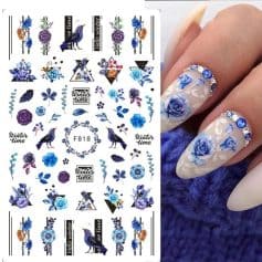 Beautiful blue floral nail art with rhinestones and intricate design, perfect for winter season manicures. Includes floral accents and winter-themed decorations for stylish nails.