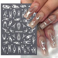 Nail art stencil for creating intricate designs on manicures, featuring white abstract shapes on a dark background, perfect for salon use and DIY nail enhancements.