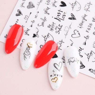 Colorful, trendy press-on nails with love-themed designs, perfect for a fashionable look.