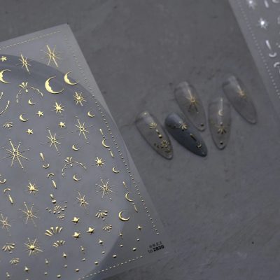 Adhesive nail decals featuring moon, star, and cosmic patterns for personalized, stylish nail art. Perfect for enhancing your manicure with a celestial theme.