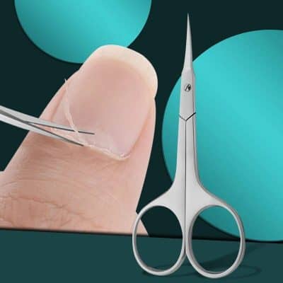 Precision manicure scissors and a fingernail trap on a fingernail.