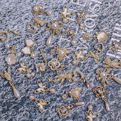 Gorgeous gold-plated butterfly and floral jewelry charms with pearls, crystal accents, perfect for customizing jewelry or accessories.