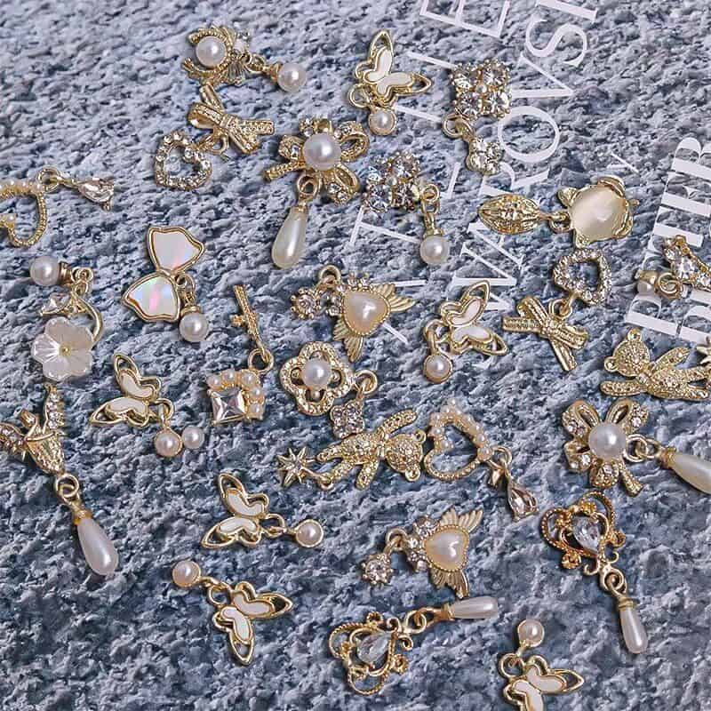 Gorgeous gold-plated butterfly and floral jewelry charms with pearls, crystal accents, perfect for customizing jewelry or accessories.