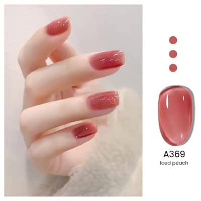 Nail polish in Iced Peach shade on perfectly manicured nails, showcasing the trendy, glossy nail color suitable for beauty salons and nail art.