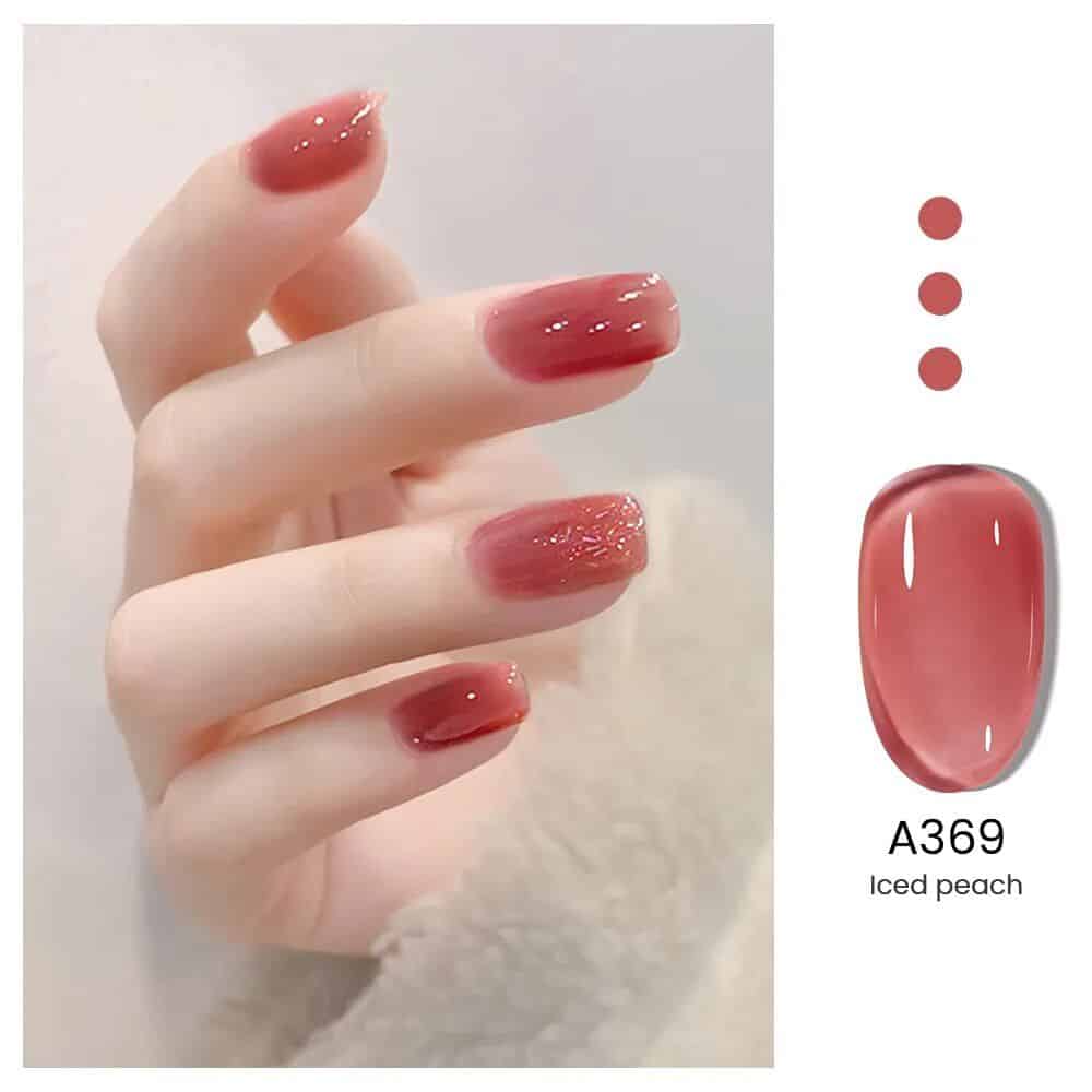 Nail polish in Iced Peach shade on perfectly manicured nails, showcasing the trendy, glossy nail color suitable for beauty salons and nail art.