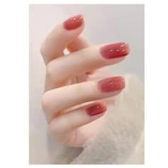 Short, glossy, pink ombre nails with subtle glitter accents. Perfect for beauty and skincare enthusiasts seeking stylish manicure ideas.