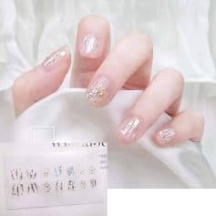 Elegant nail design with iridescent finish and star glitter accents, perfect for trendy fashion and beauty enthusiasts seeking high-quality manicure at Monalisa Store.