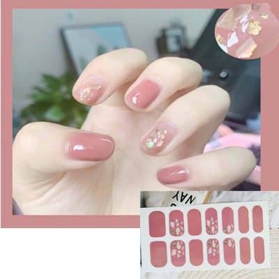 Beautiful gel manicures with floral nail art and iridescent accents, perfect for stylish and trendy looks. The design features soft pink tones with shimmer details, ideal for any special occasion.