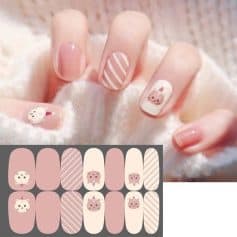 Delicate pastel pink and white animal-themed nail design with striped accents, perfect for a cute and fashionable manicure. Show off adorable animal nail art with detailed character illustrations.