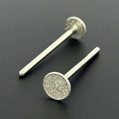 Elegant silver stud earrings with textured round discs for a modern, stylish look, perfect for complementing any outfit, available at Monalisa Store.