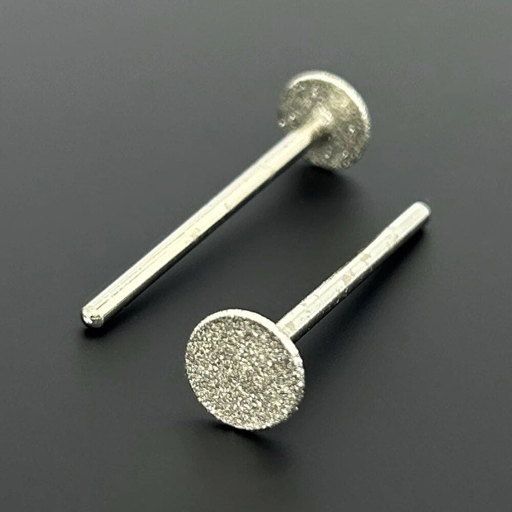 Elegant silver stud earrings with textured round discs for a modern, stylish look, perfect for complementing any outfit, available at Monalisa Store.