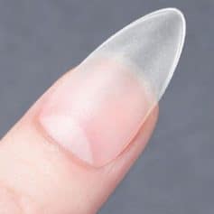 Close-up of a clear gel nail extension on a natural nail for a flawless, durable manicure. Perfect for elegant nail decor and professional nail styling.