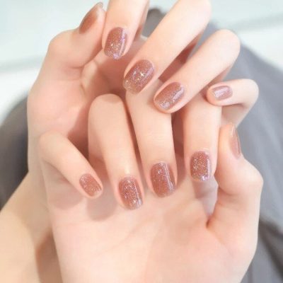 Elegant glittery gel nail art with a soft brown base, perfect for a stylish look. Professional nail design from Monalisa Store, enhancing your beauty.