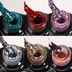 Close-up of colorful glitter nail polishes with applicators, showcasing sparkly, shimmering finishes perfect for stylish nails and beauty enhancement.