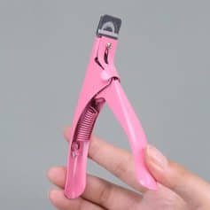 Pink nail clipper for precise nail trimming and grooming. Ergonomic design with safety features. Perfect for DIY manicures and pedicures. Compact and easy to use.