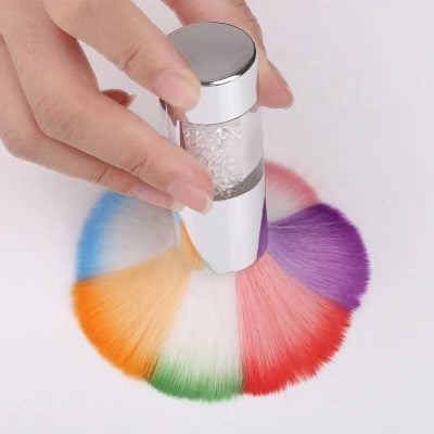 A hand holding a sensory vaporizer with colorful powder displayed in a circular pattern, highlighting vibrant options for eye and skin health enhancement from Monalisa Store.