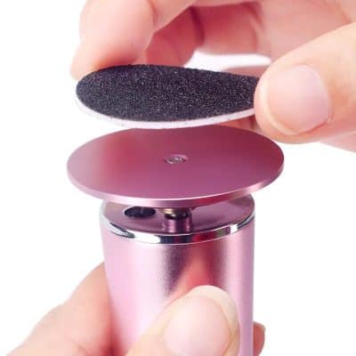 Compact blackhead remover device with suction head for deep pore cleaning and blackhead removal.