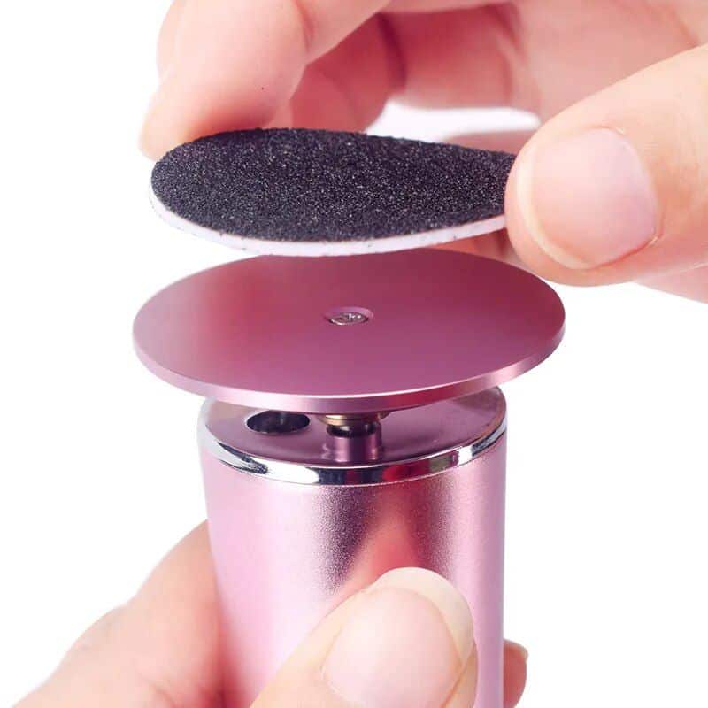 Compact blackhead remover device with suction head for deep pore cleaning and blackhead removal.