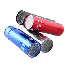 Bright red, blue, and black energy drink cans filled with ice on a white background.
