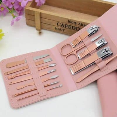 Portable manicure set for professional nail care and grooming. Includes cuticle nippers, scissors, tweezers, and tools in a stylish pink case. Perfect for salons or home use.