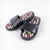 Comfortable black massage slippers with acupressure massage technology.