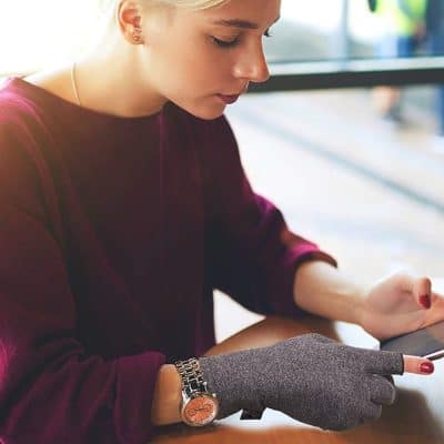 Elegant woman browsing with smartphone at Monalisa Medical Store, showcasing luxury watches and stylish accessories in a modern healthcare environment.