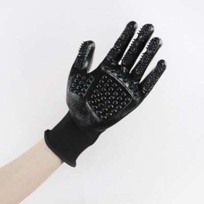 Black glove with textured grip surface for secure handling in medical, dental, or industrial settings. Ergonomic design enhances comfort and dexterity for professional use.