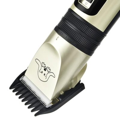 Electric hair clipper with adjustable blades, ideal for professional grooming and haircuts. Features a cute cartoon design on the metal surface, ergonomic handle for easy use.