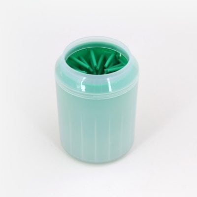 A close-up of a container holding green dental floss picks used for effective oral hygiene and dental care, available at Monalisa Store.