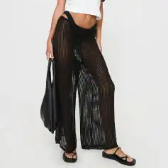 Stylish black crocheted beach pants with drawstring waist, side slits, and see-through pattern perfect for beachwear and summer fashion.