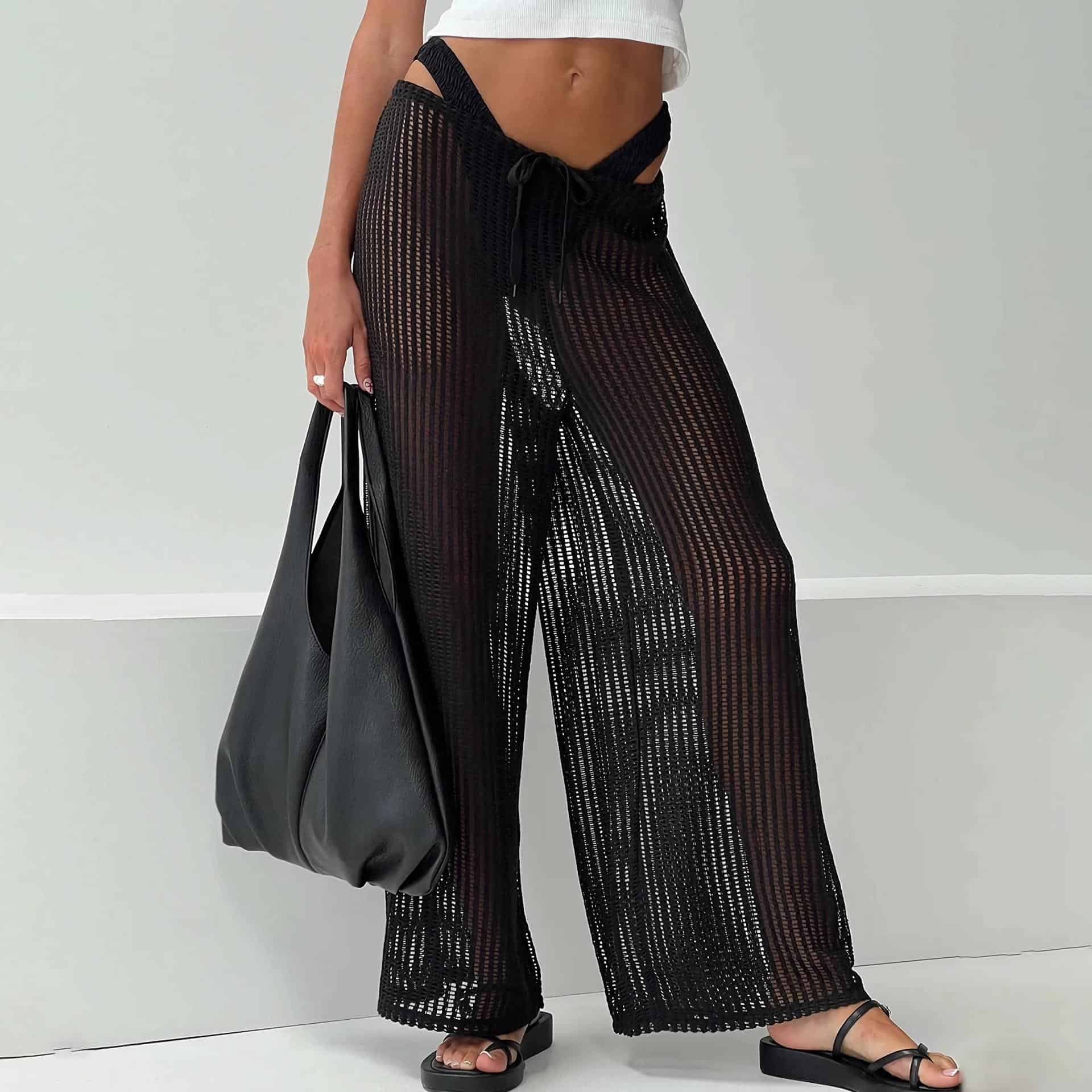 Enhance your summer wardrobe with black mesh wide-leg pants for a breezy, fashionable look. Ideal for casual or vacation wear, these lightweight, see-through pants add a trendy touch to your outfit.