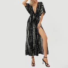 Stylish black and white patterned maxi dress with high slit, perfect for summer, beachwear, or resort fashion. Features comfortable fit and trendy design.