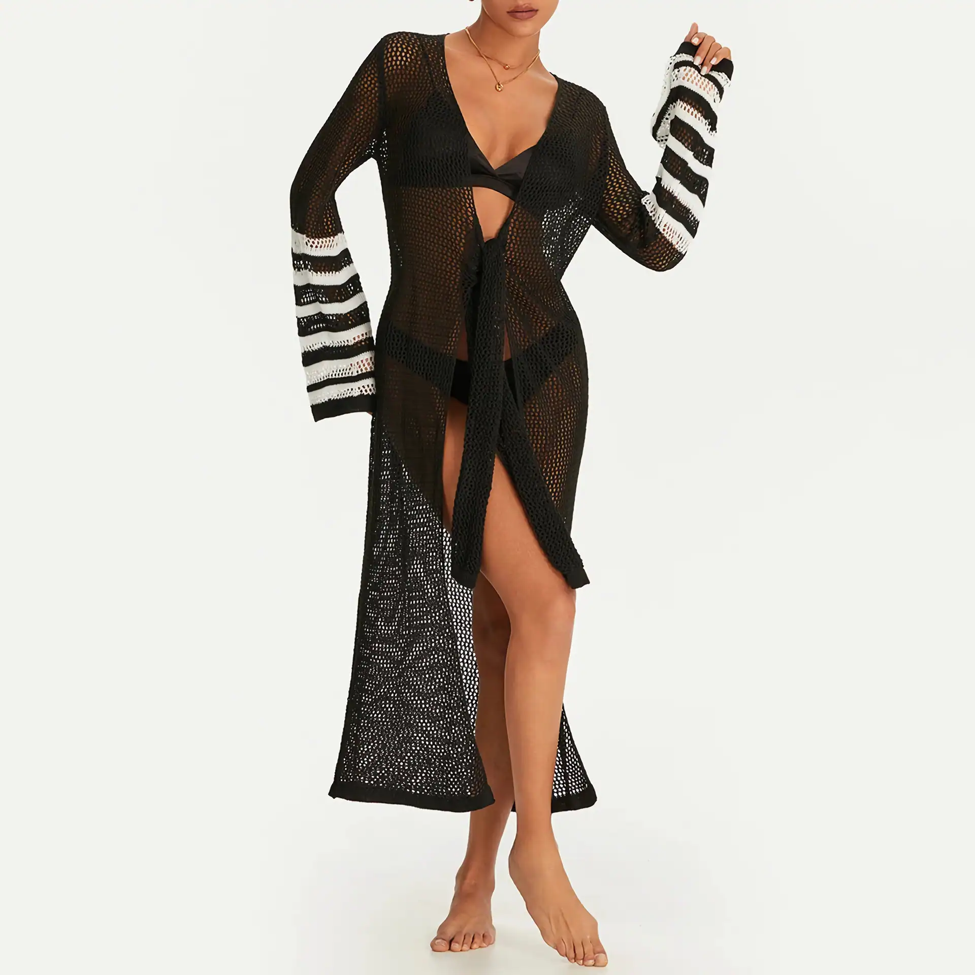 Stylish black crochet beach cover-up with striped sleeve details, perfect for swimming pool or beach days, lightweight and breathable for a comfortable summer look.