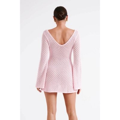 A stylish pink crochet dress with a deep V back, perfect for fashionable women seeking trendy and comfortable outfits.