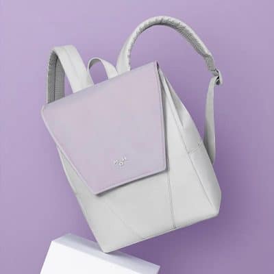 Elegant white tote backpack with lavender detachable pouch, ideal for versatile travel and shopping needs.