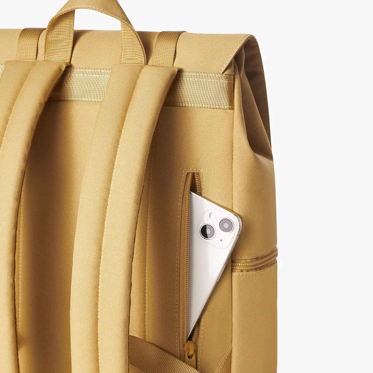 A yellow backpack with multiple compartments and a side pocket holding a smartphone, ideal for travel, school, or daily use. Durable material and ergonomic design ensure comfort and practicality.
