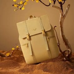 Optical shop display features a trendy beige backpack with multiple zippered pockets, ideal for stylish outings and everyday carry needs.