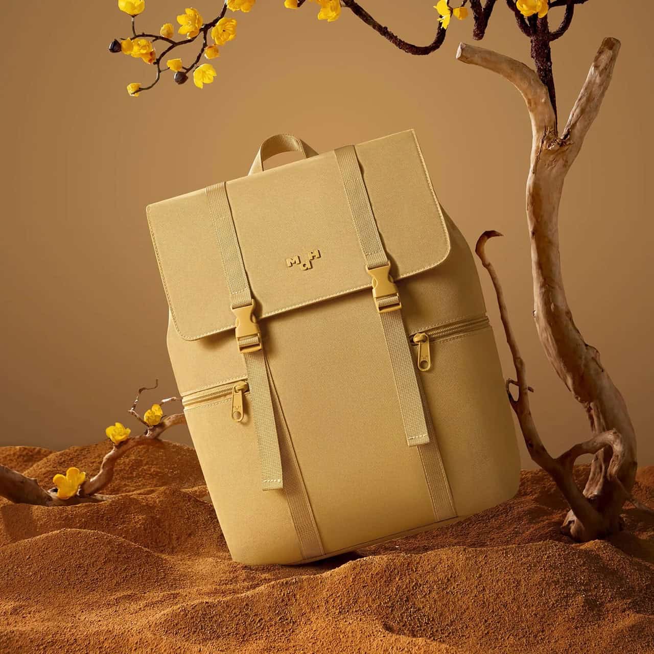 Optical shop display features a trendy beige backpack with multiple zippered pockets, ideal for stylish outings and everyday carry needs.