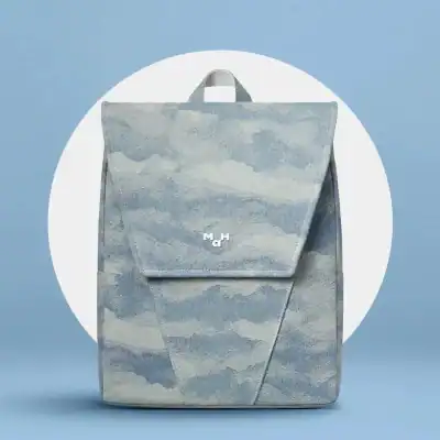 A trendy tote bag designed with a soft blue and white cloud pattern, perfect for carrying essentials. Ideal for fashion-forward individuals seeking a blend of functionality and style.