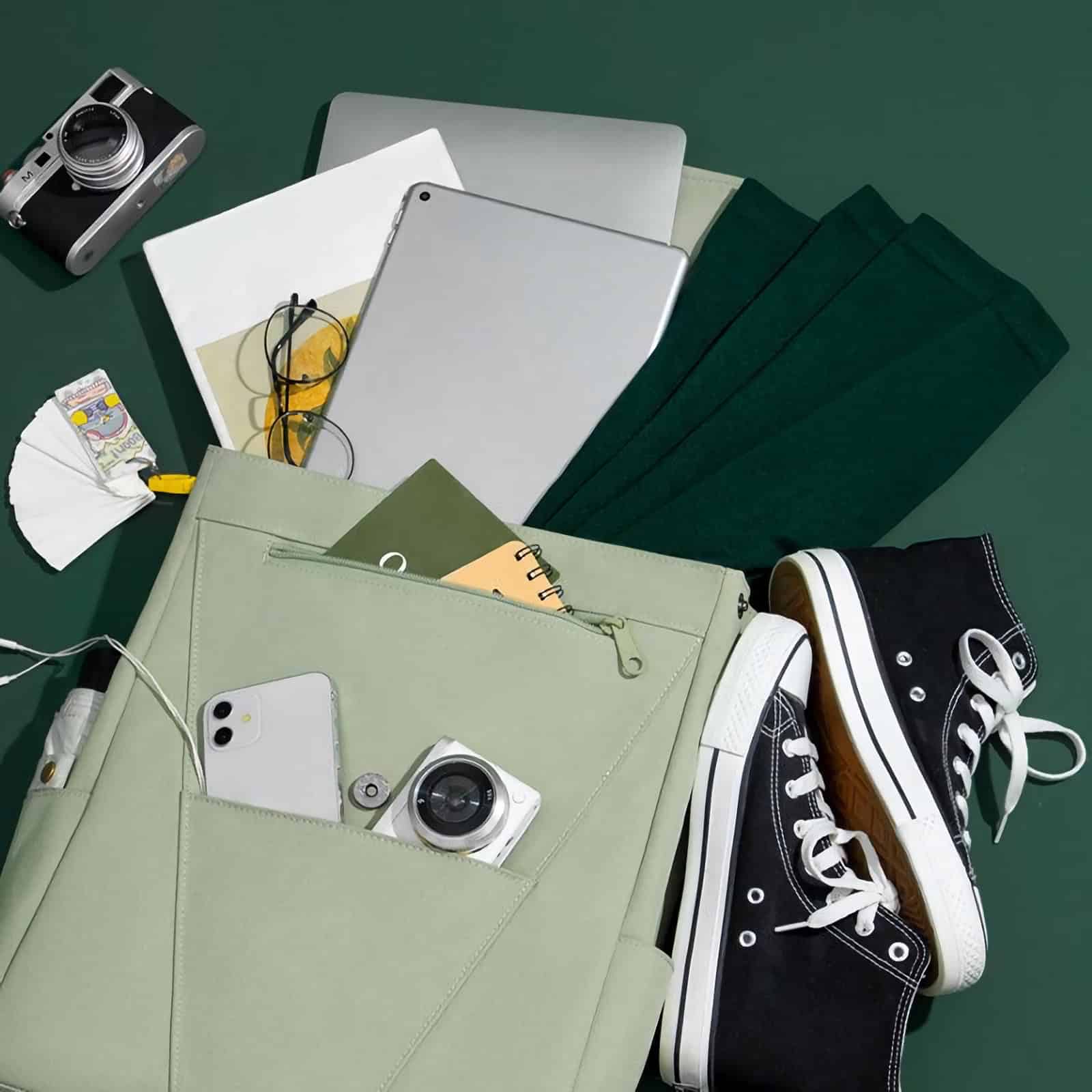 A modern workspace featuring laptops, a camera, eyeglasses, notebooks, and sneakers, perfect for eyewear shopping and optical accessories at Monalisa Store.