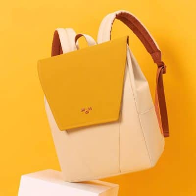Stylish yellow and beige fashion backpack for women and men. Perfect for daily use, travel, and work with ample storage and modern design.